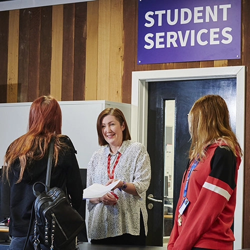 A student sketching at a desk