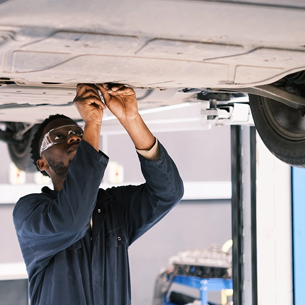 man underneath care making repairs