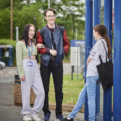 Students standing at bus stop