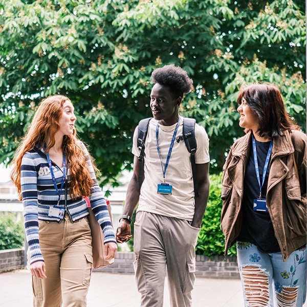 Three students walking side by side
