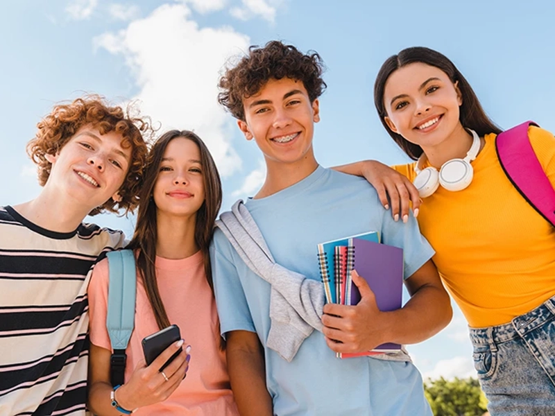 Four students under blue sky