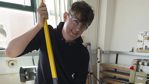 Student sawing metal