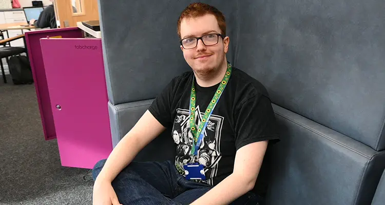 Student sitting on chair looking to camera