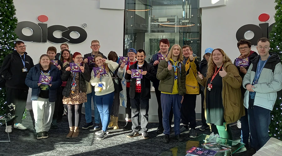 A large group of students in a company's reception area
