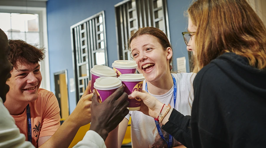 Four young students toasting with toffee