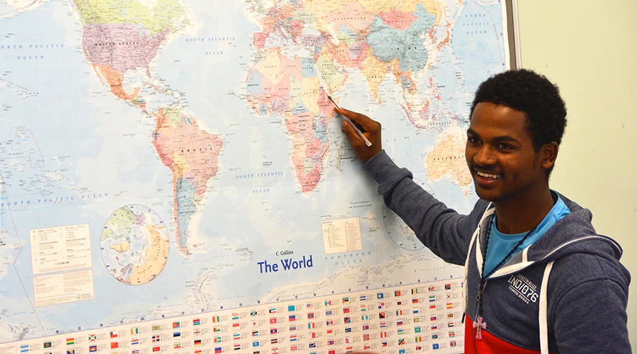 A student pointing to Africa on a large map