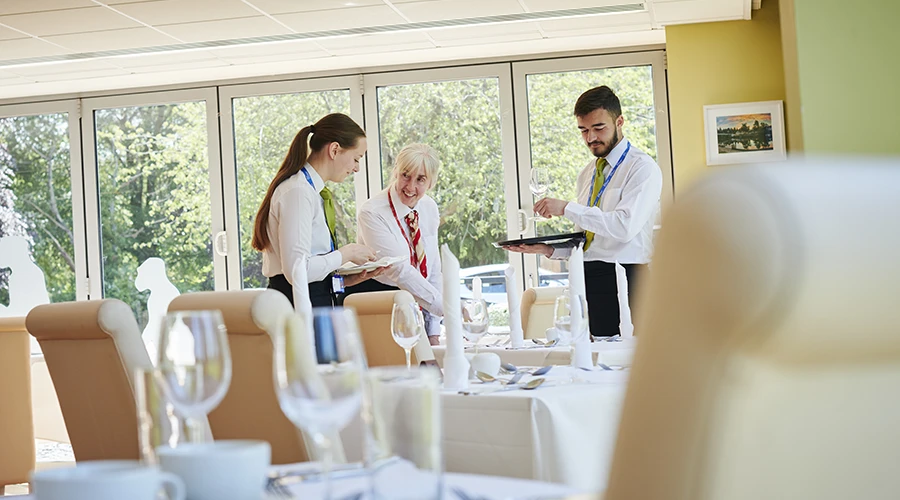 Students being supervised by teacher in restaurant 