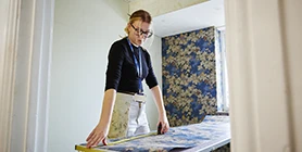 Student measuring wallpaper 