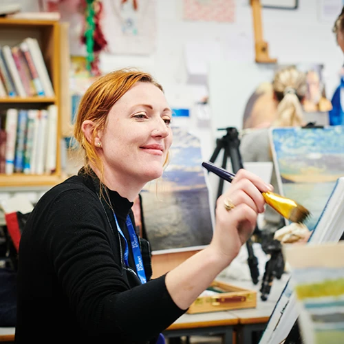 young woman in studio painting